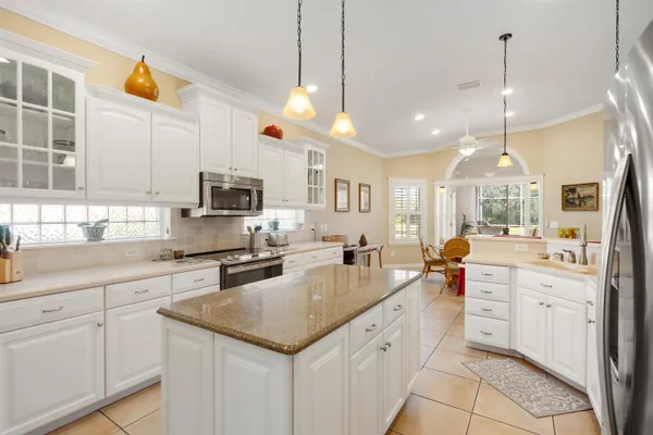 a view of a dining room with furniture and a chandelier