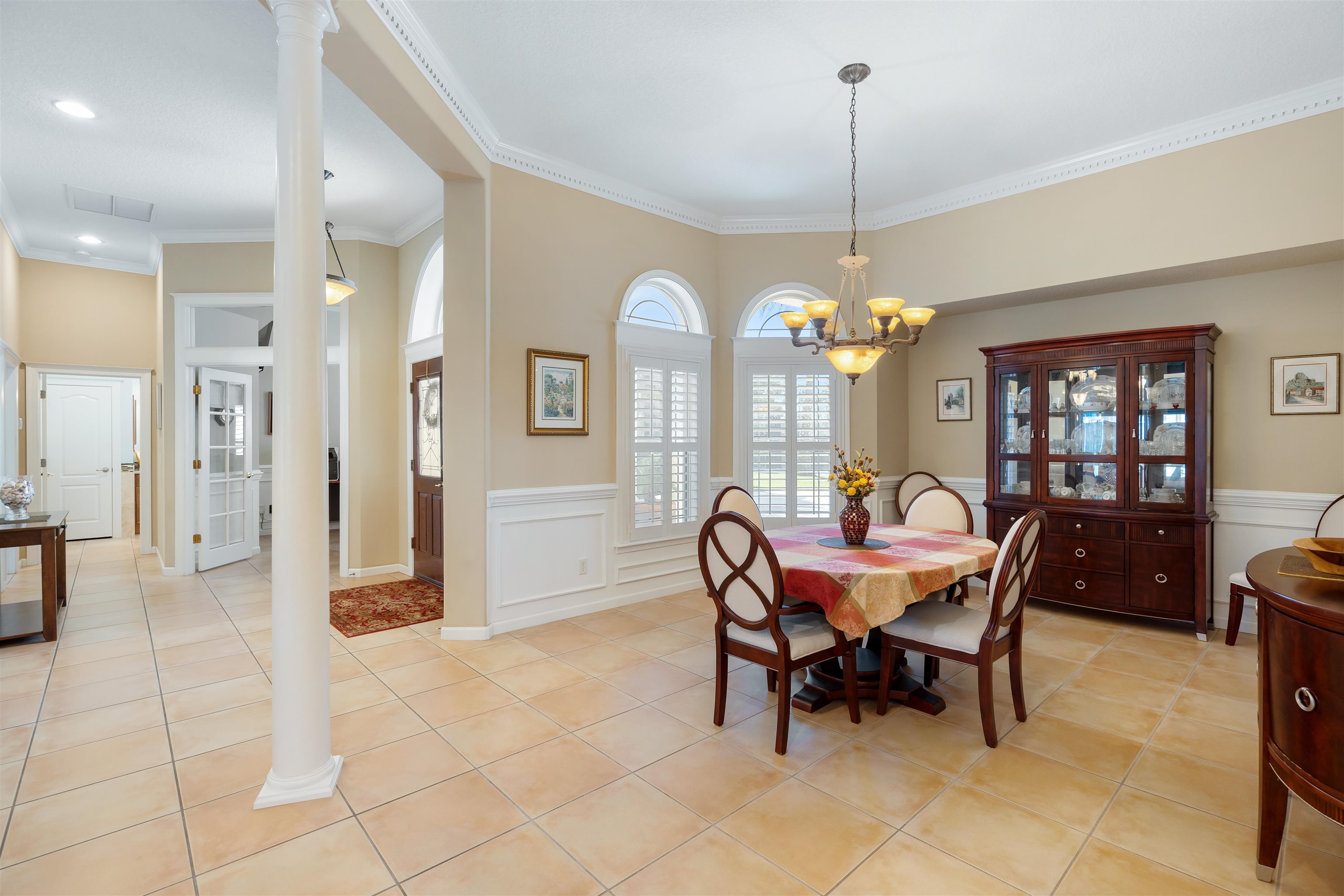 314 Fiddlers Point Drive St. Augustine, FL 32080 - Photo 15 of 54 a dining room with furniture a chandelier and a rug