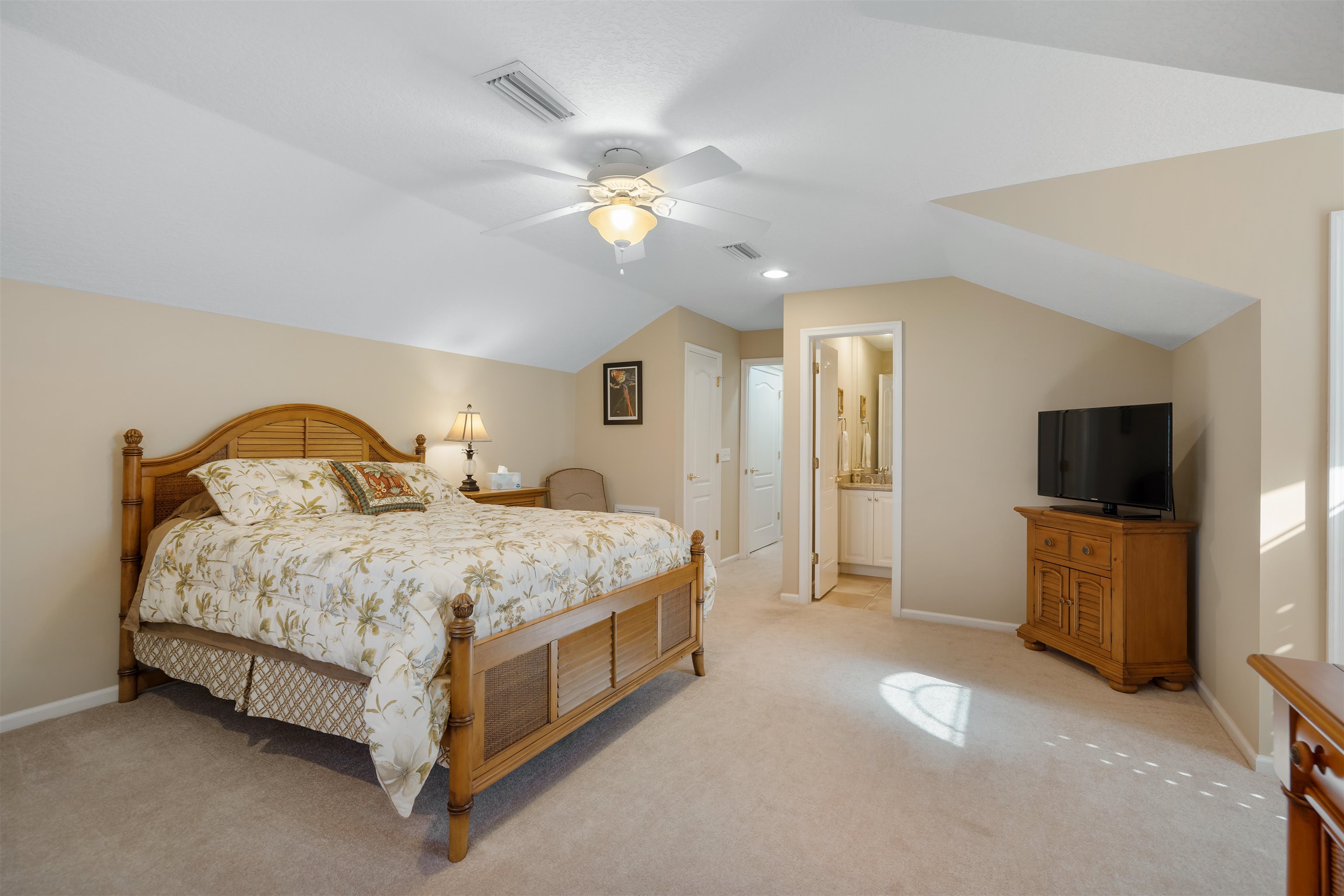 314 Fiddlers Point Drive St. Augustine, FL 32080 - Photo 39 of 54 a spacious bedroom with a bed and a flat screen tv