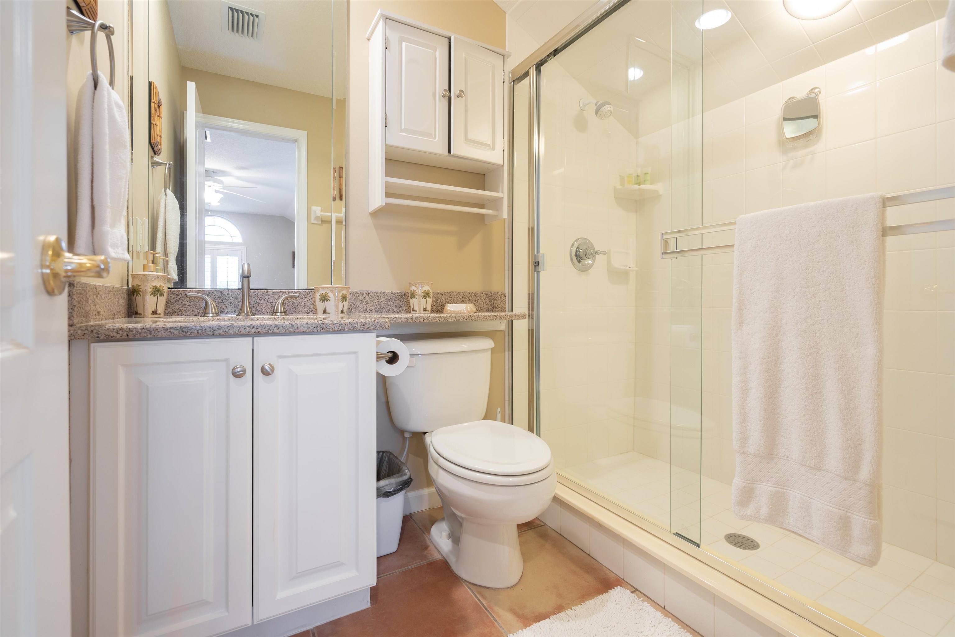 314 Fiddlers Point Drive St. Augustine, FL 32080 - Photo 40 of 54 a bathroom with a granite countertop toilet a sink and a mirror