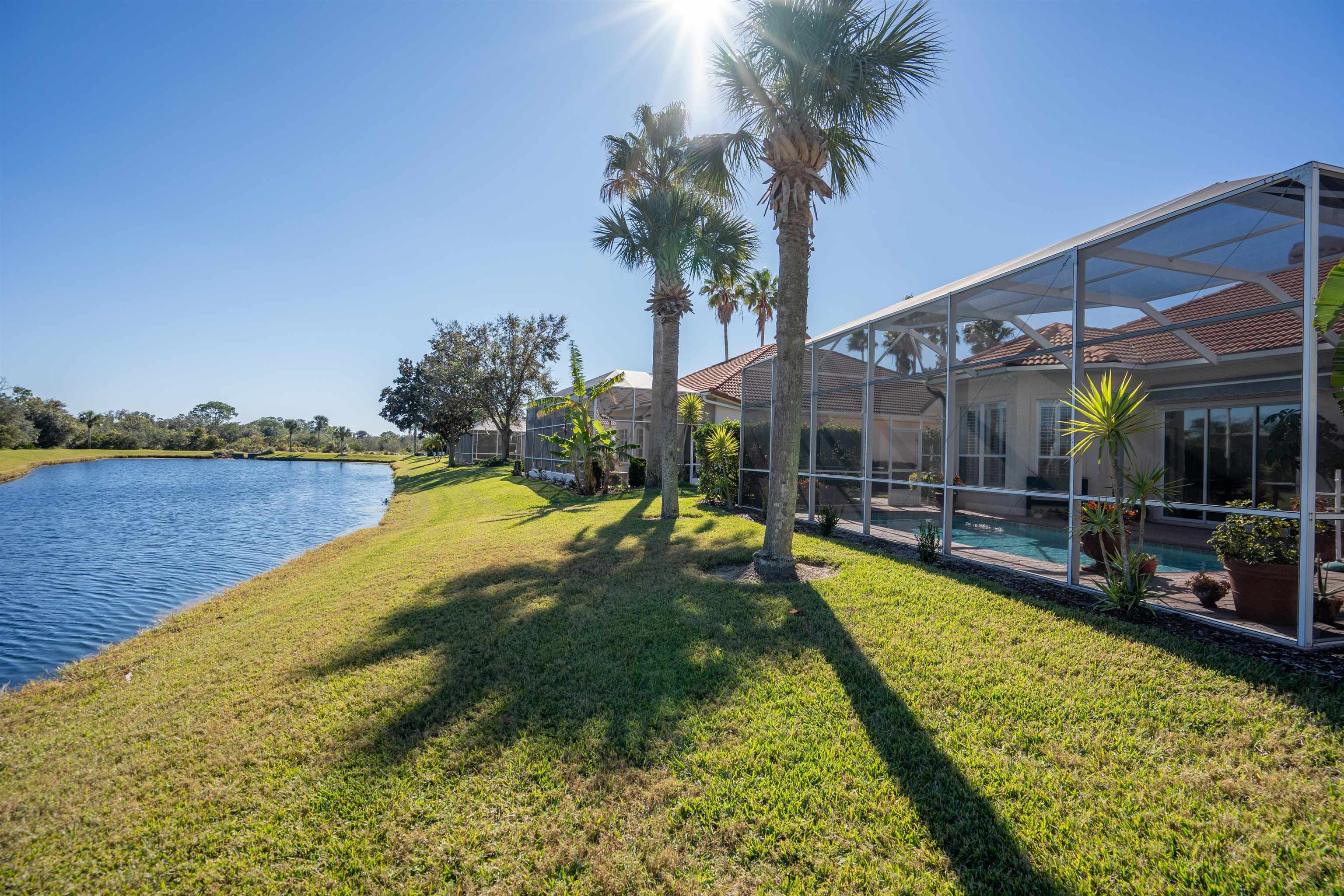 314 Fiddlers Point Drive St. Augustine, FL 32080 - Photo 45 of 54 a view of a swimming pool with a patio and a garden