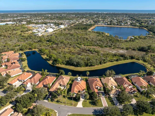 an aerial view of a house with a yard large tree and deck
