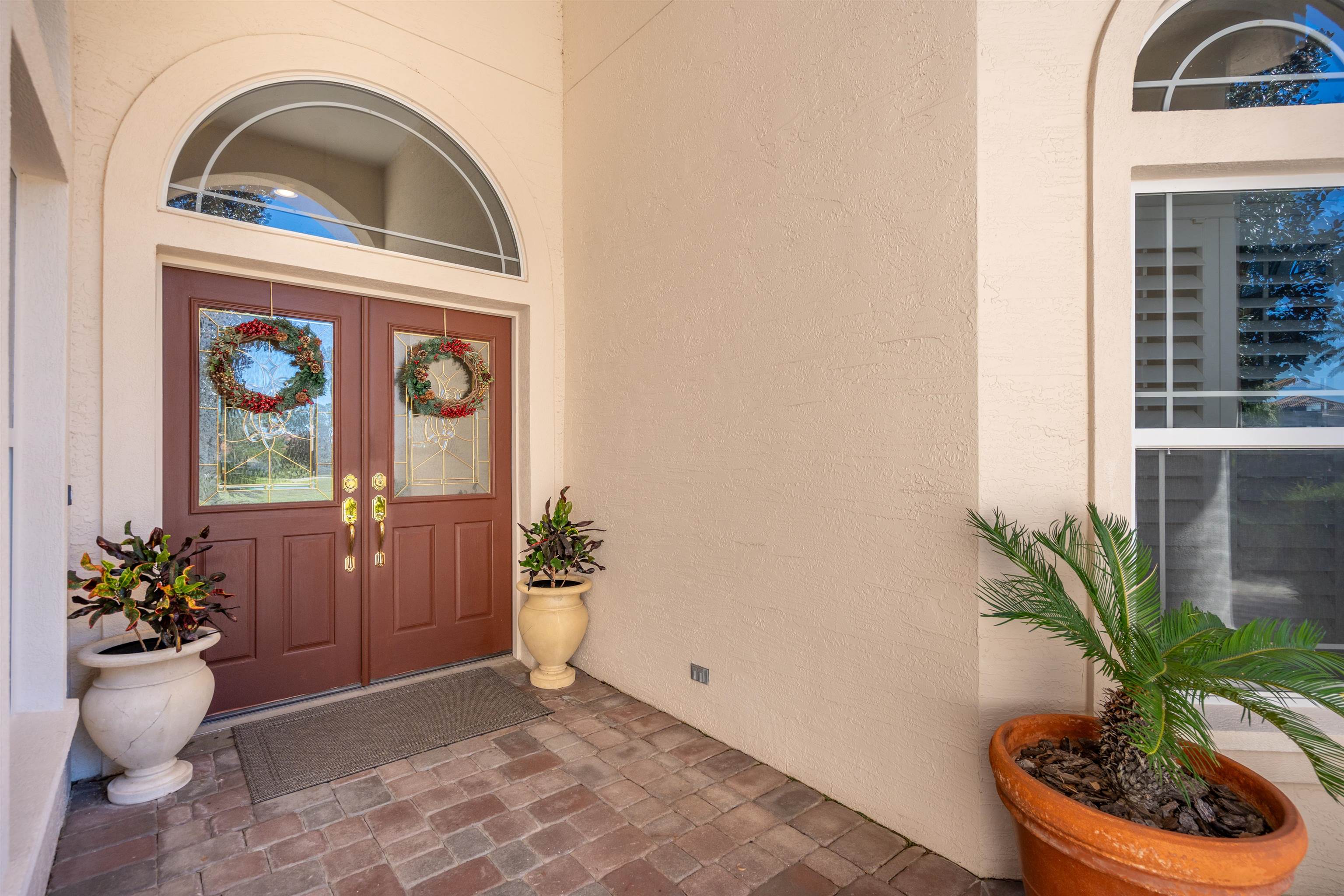 314 Fiddlers Point Drive St. Augustine, FL 32080 - Photo 7 of 54 a view of front door of a house with a potted plant