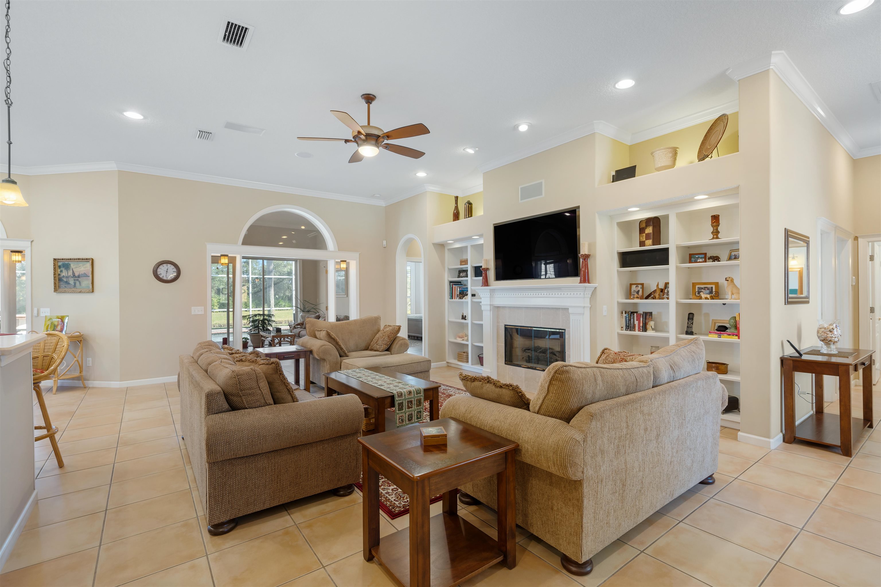 314 Fiddlers Point Drive St. Augustine, FL 32080 - Photo 10 of 54 a living room with furniture a fireplace and a flat screen tv