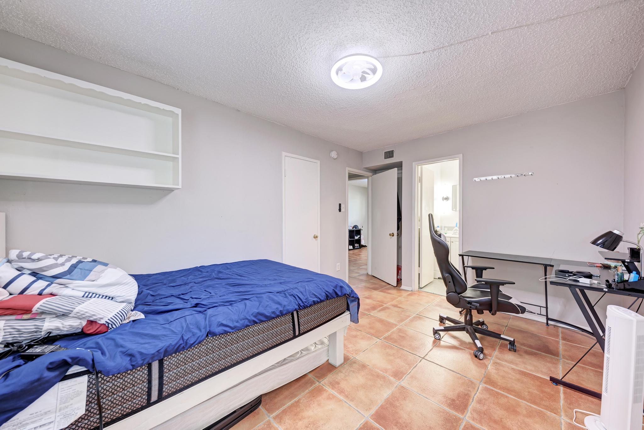 803 West 28th Street, Unit 102 Austin, TX 78705 - Photo 11 of 16 a bedroom with a bed and a desk