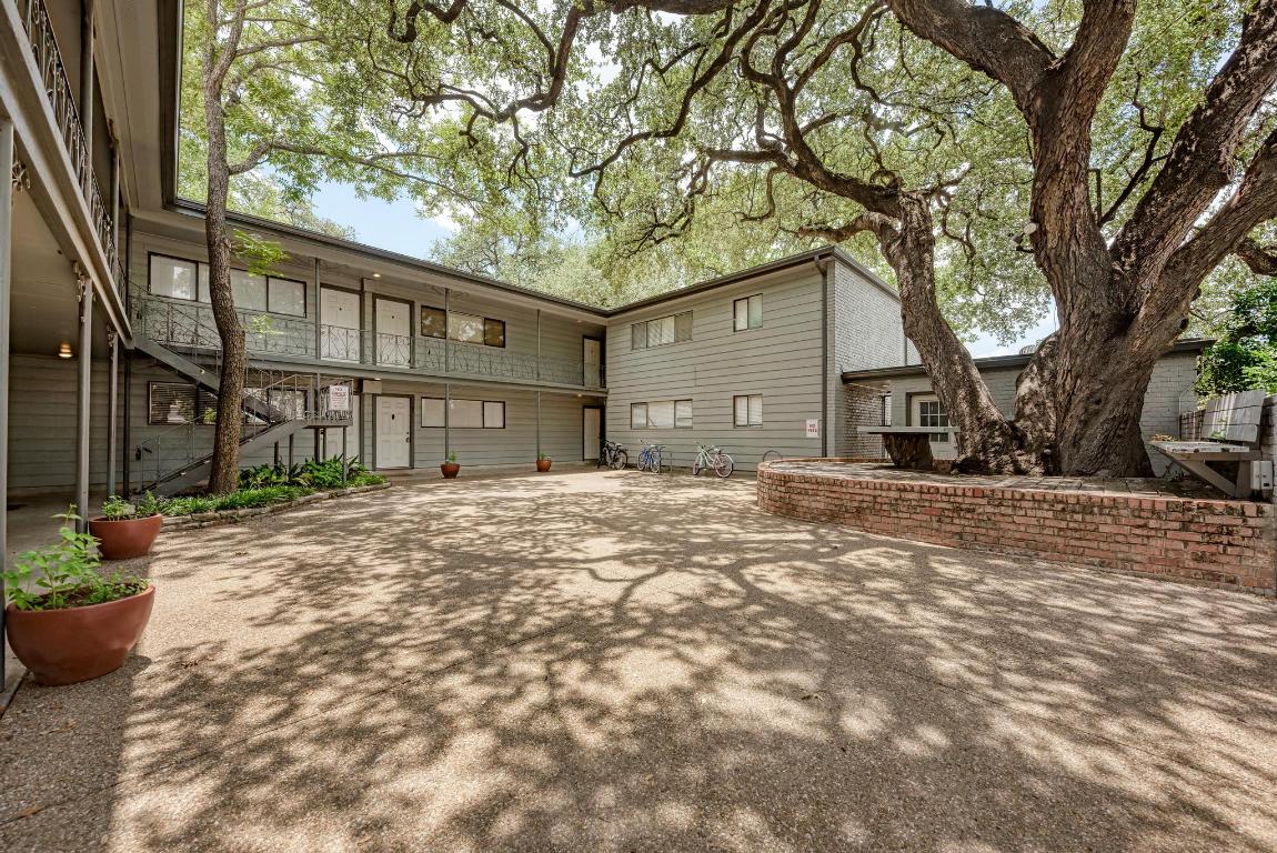 803 West 28th Street, Unit 102 Austin, TX 78705 - Photo 2 of 16 a front view of a house with a yard and garage