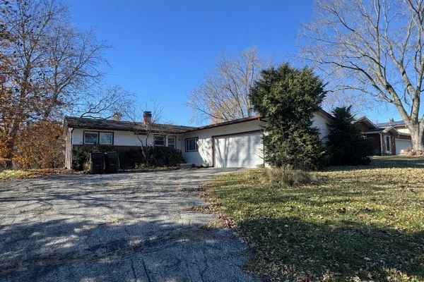 a house that has a tree in front of it