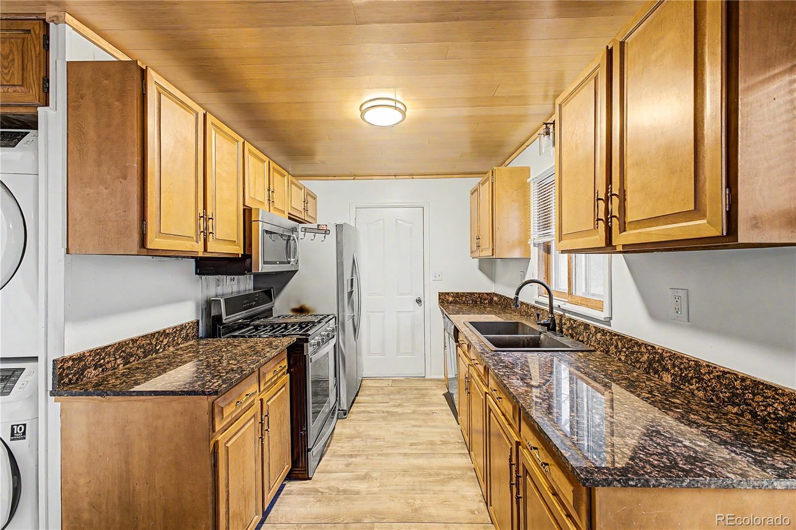 145 Bailey Drive Bailey, CO 80421 - Photo 9 of 31 a kitchen with stainless steel appliances granite countertop a stove a sink and a microwave