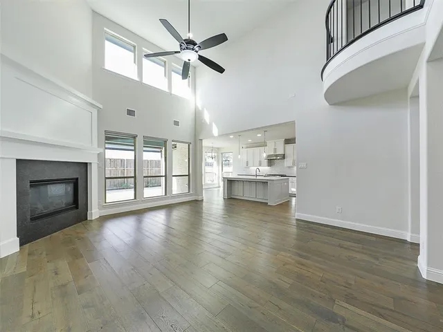 an empty room with a window and ceiling fan