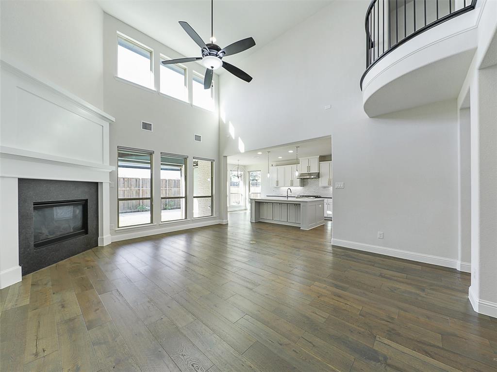8473 Gerbera Daisy Road Frisco, TX 75035 - Photo 16 of 39 a view of an empty room with wooden floor fireplace and a window