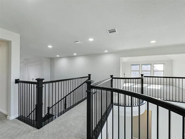 a bathroom with a bathtub shower sink vanity mirror and toilet