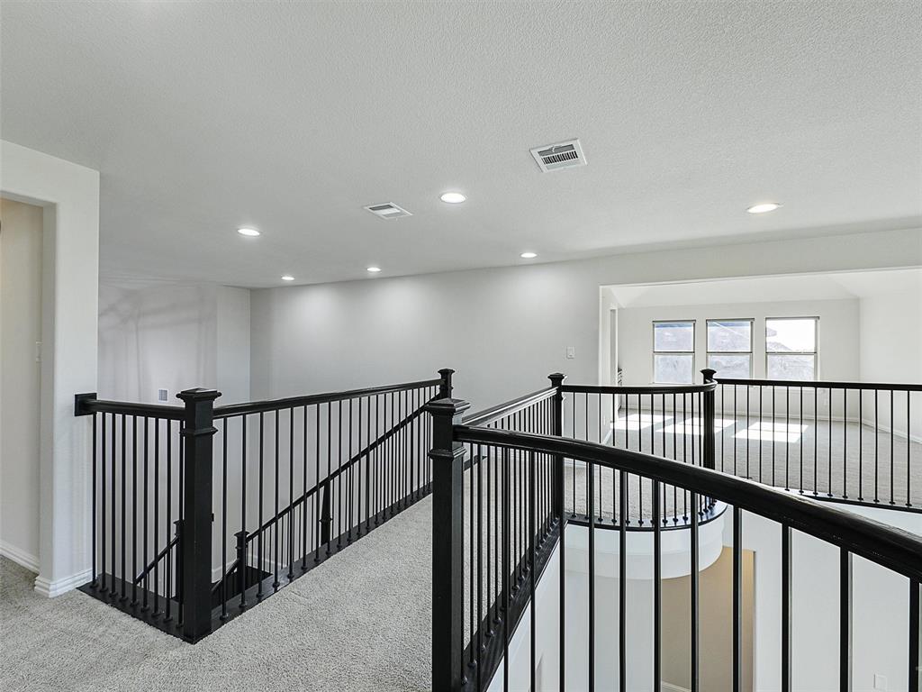 8473 Gerbera Daisy Road Frisco, TX 75035 - Photo 27 of 39 a view of staircase with wooden floor