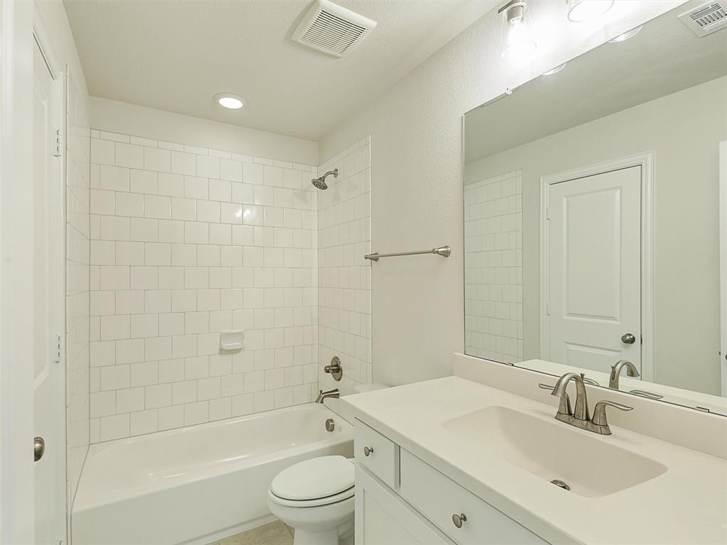 8473 Gerbera Daisy Road Frisco, TX 75035 - Photo 29 of 39 a bathroom with a bathtub shower sink vanity mirror and toilet