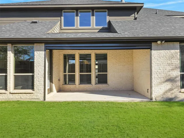 a view of a swimming pool with couches and lounge chairs