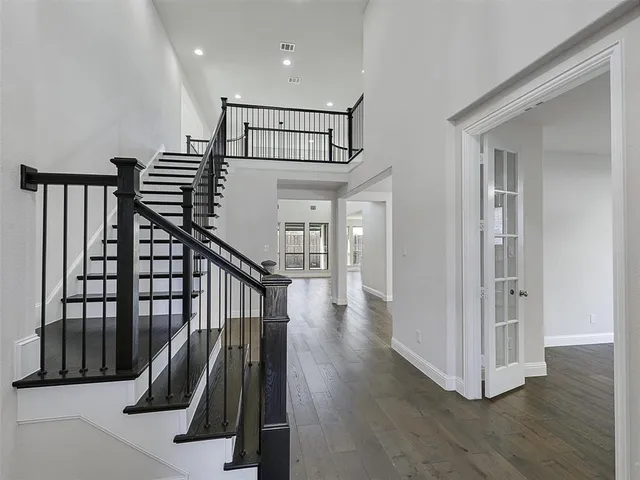 a view of a room with wooden floor