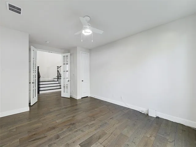a view of a room with wooden floor staircase and a kitchen