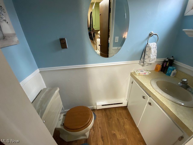 183 Trails End Road Toronto, OH 43964 - Photo 22 of 25 Bathroom with toilet, a baseboard heating unit, vanity, and hardwood / wood-style floors