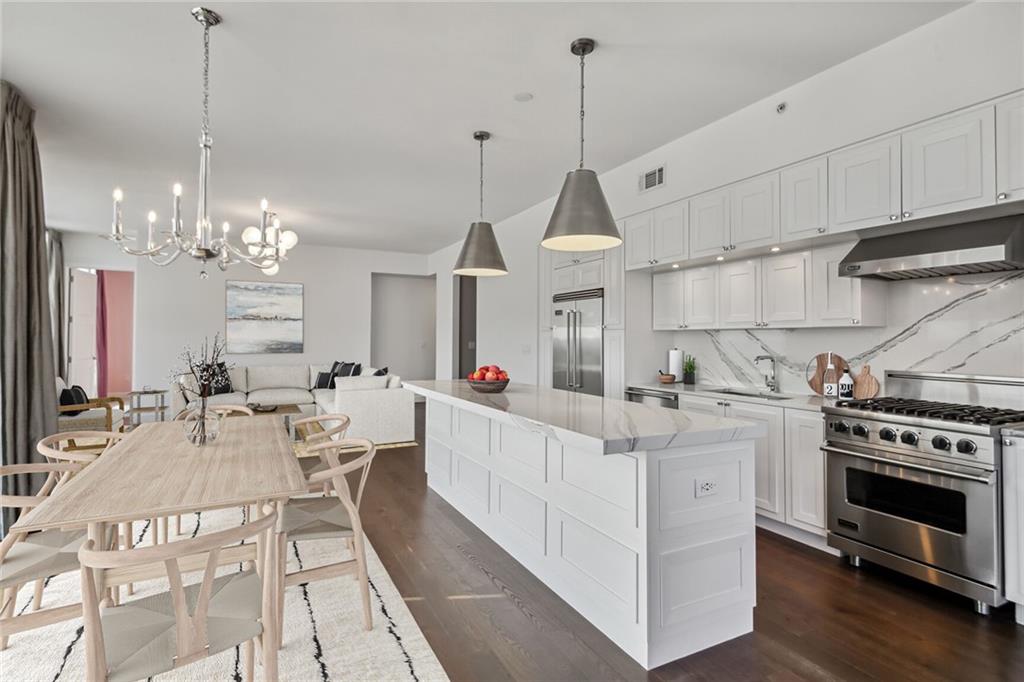 1820 Peachtree Road Northwest, Unit 1107 Atlanta, GA 30309 - Photo 1 of 35 a view of a kitchen and living room with wooden floor