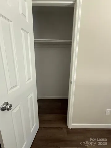 an empty room with wooden floor and window