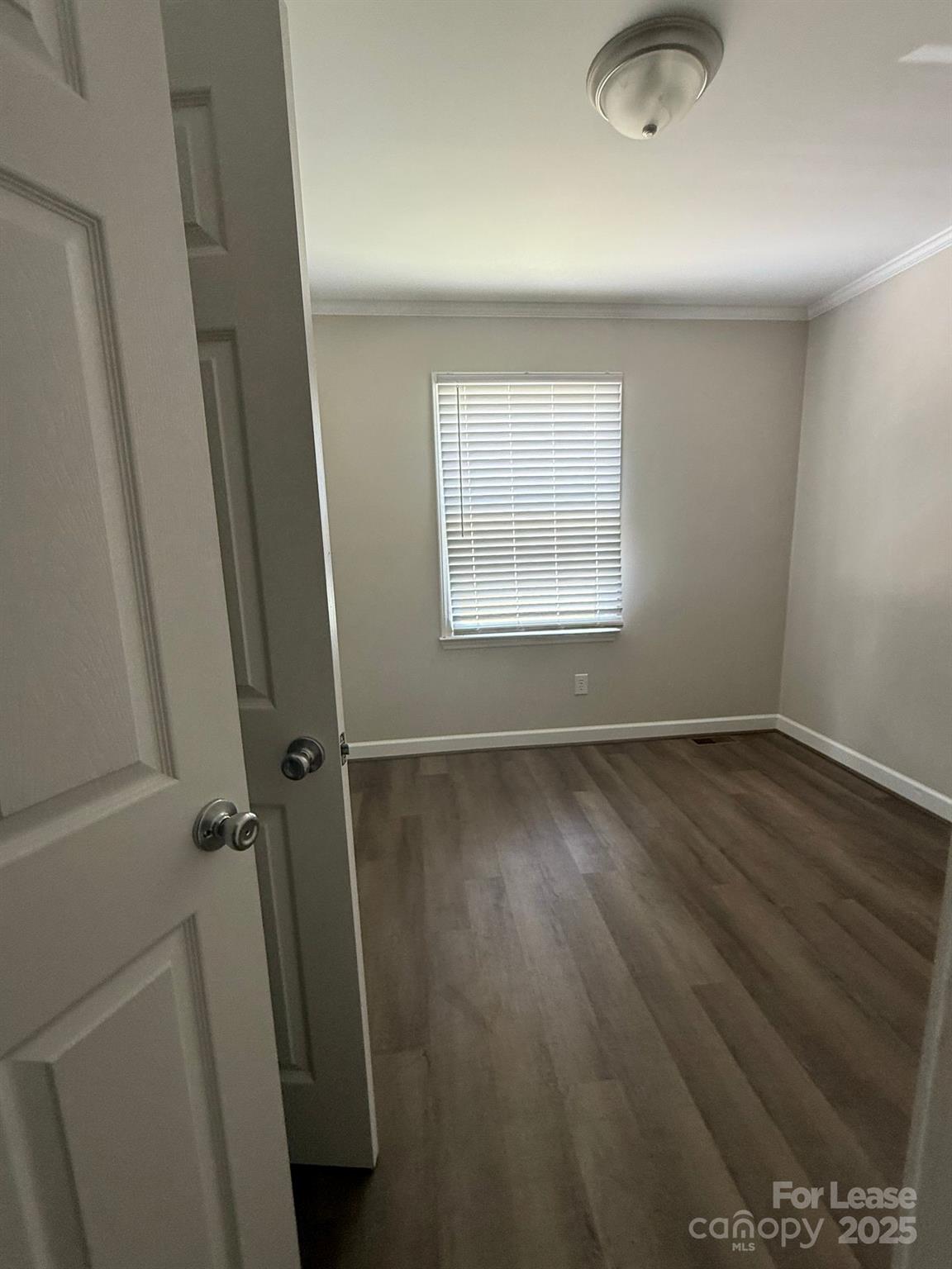 705 Oakshade Avenue Kannapolis, NC 28083 - Photo 15 of 21 an empty room with wooden floor and window