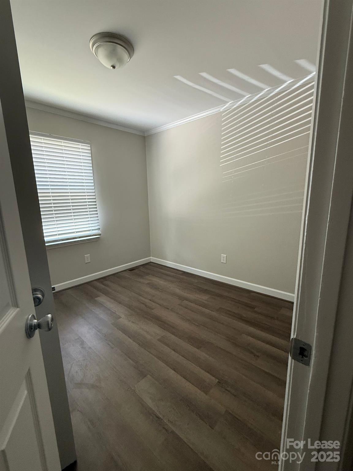 705 Oakshade Avenue Kannapolis, NC 28083 - Photo 16 of 21 an empty room with wooden floor and windows