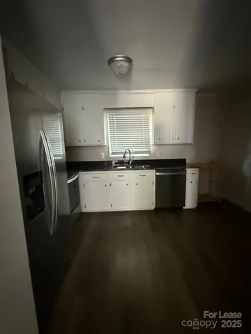 a kitchen with stainless steel appliances a sink stove and cabinets