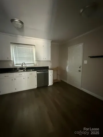 a view of an empty room and wooden floor