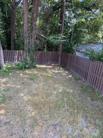 a view of outdoor space with wooden fence