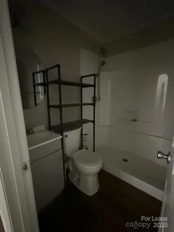 a bathroom with a toilet and a shower