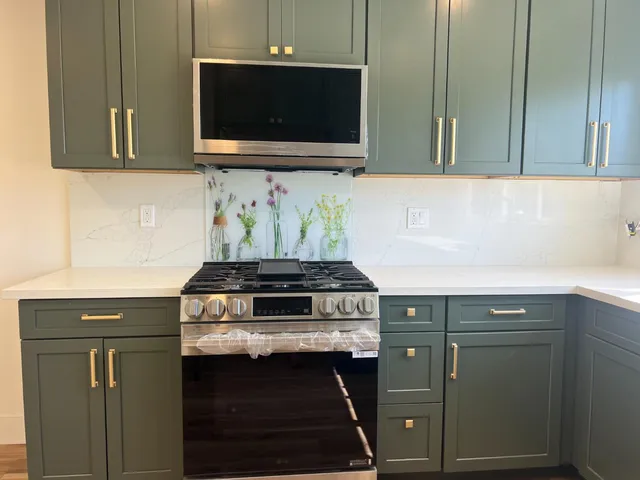 a kitchen with stainless steel appliances a stove and a microwave