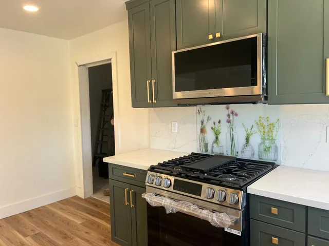 a kitchen with a stove and a microwave