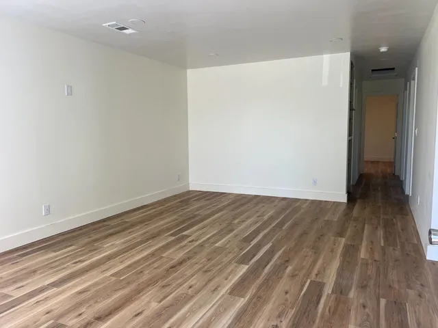 a view of a room with wooden floor and a sink