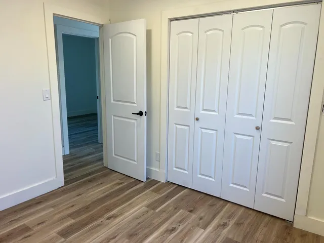 a view of a room with wooden floor