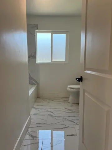 a bathroom with a toilet and a sink