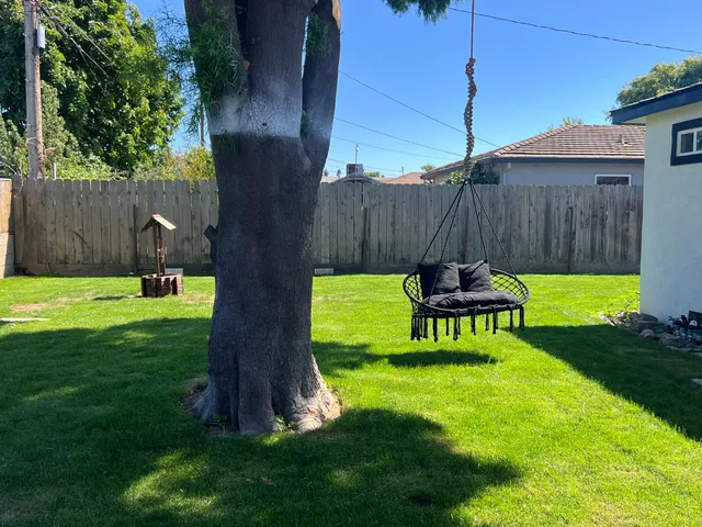 a view of a backyard with a table and chairs