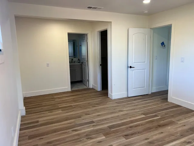a view of wooden floor and closet in a room