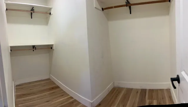 a view of a room with wooden floor