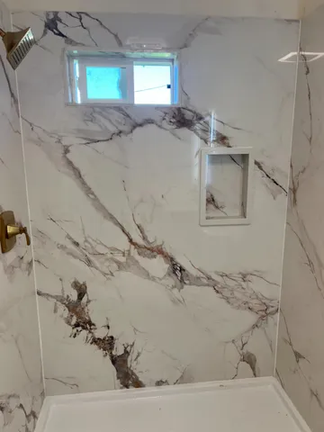 a bathroom with a bathtub and a window