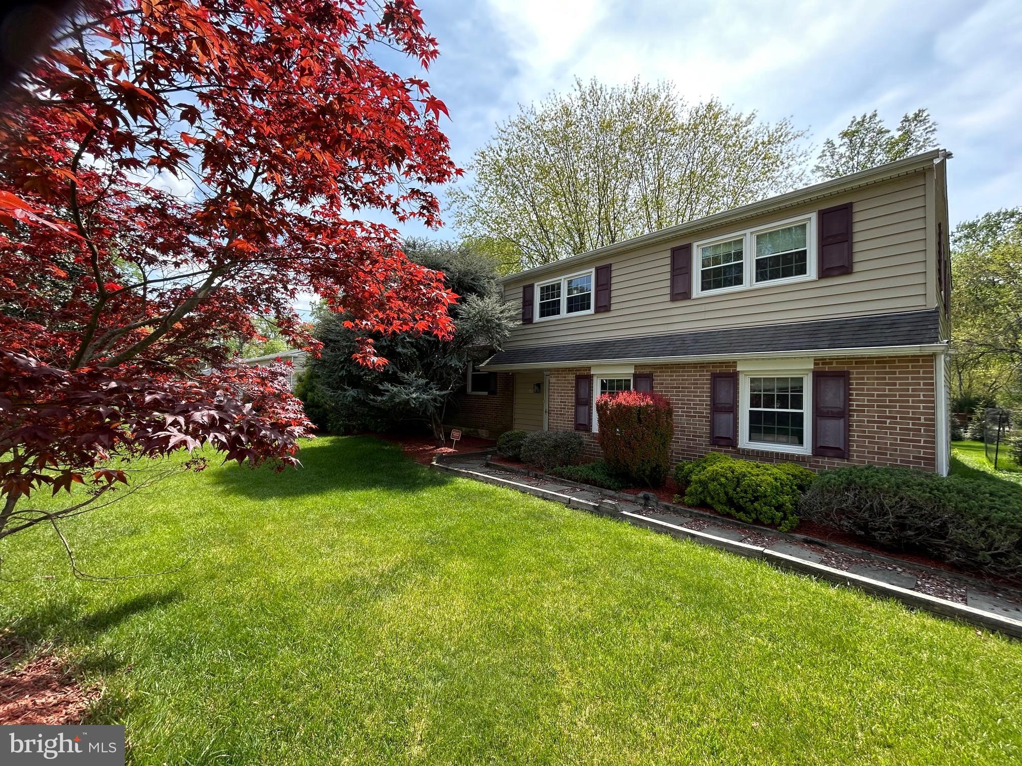703 Blue Hill Road Wallingford, PA 19086 - Photo 2 of 39 a front view of house with yard and green space