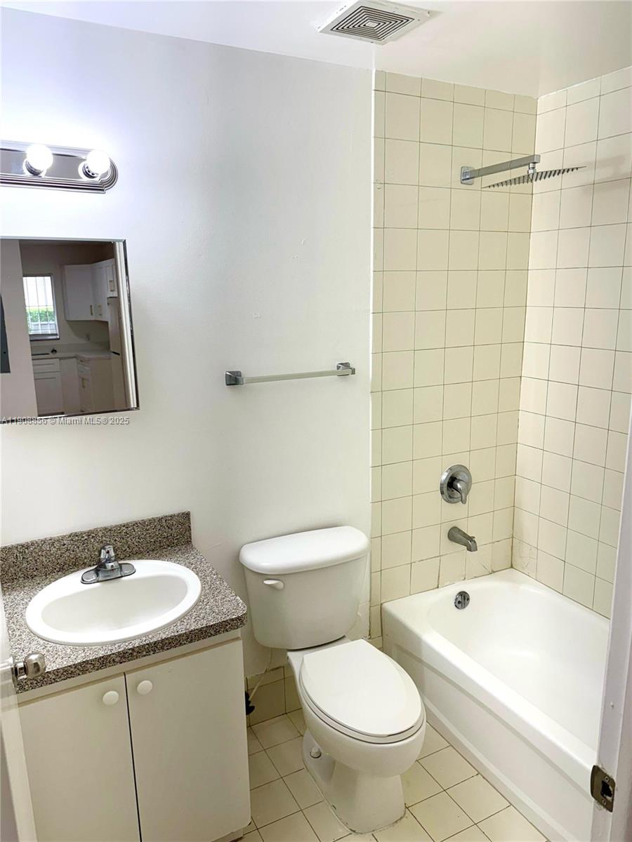 13942 Northeast 2nd Avenue, Unit 2B Miami, FL 33161 - Photo 9 of 10 a bathroom with a sink a toilet and shower