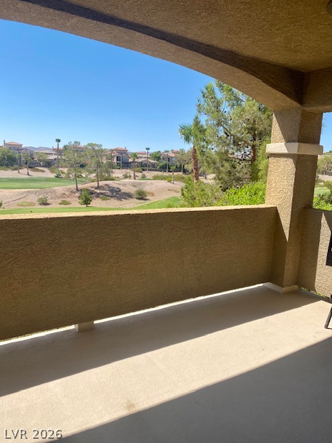 159 Tall Ruff Drive Las Vegas, NV 89148 - Photo 21 of 31 An arched covered balcony looks out over a rolling golf course and mature desert landscaping.