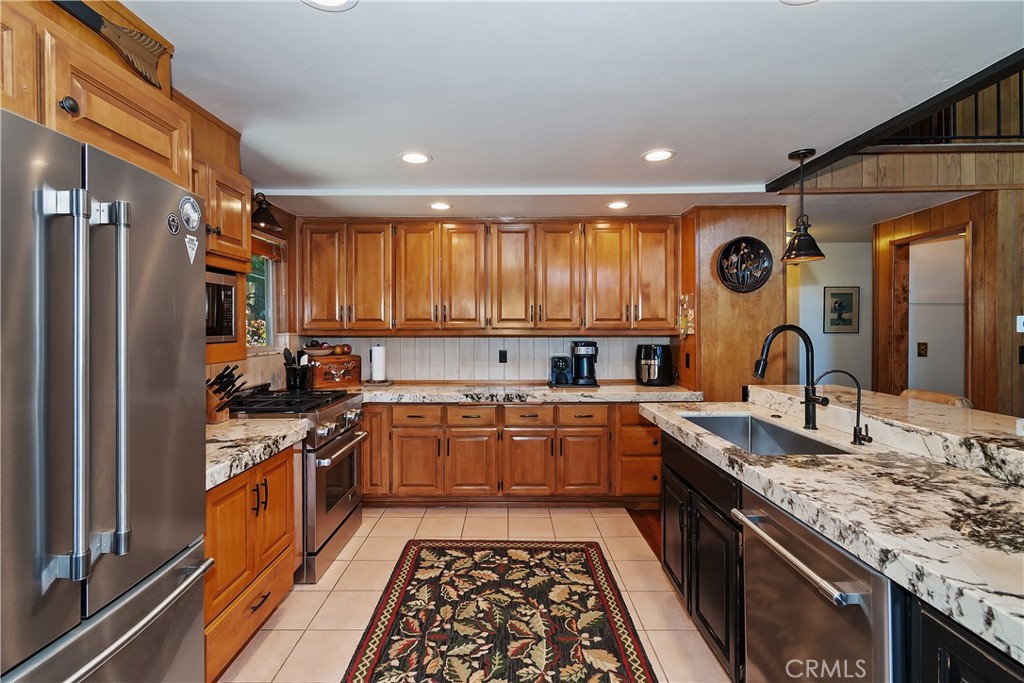 158 Golf Course Road Lake Arrowhead, CA 92391 - Photo 15 of 75 a large kitchen with stainless steel appliances granite countertop a stove and a sink