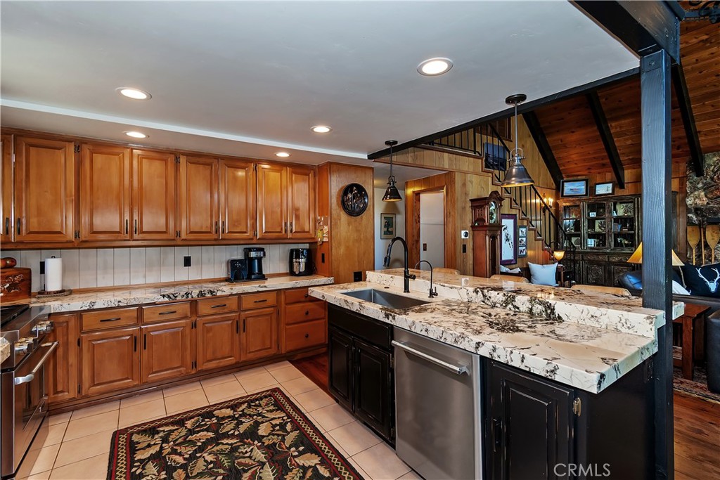 158 Golf Course Road Lake Arrowhead, CA 92391 - Photo 16 of 75 a kitchen with stainless steel appliances granite countertop a sink stove and cabinets