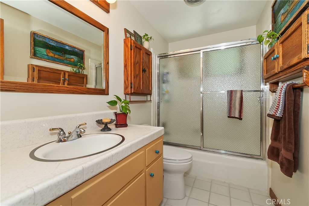 158 Golf Course Road Lake Arrowhead, CA 92391 - Photo 21 of 75 a bathroom with a sink toilet and shower