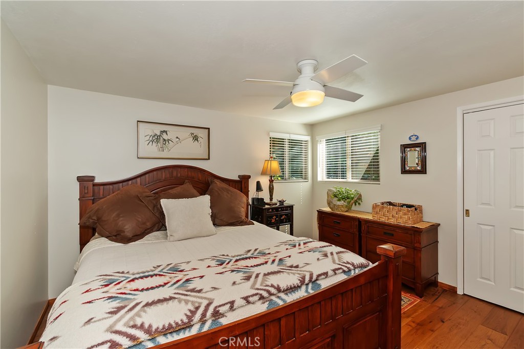 158 Golf Course Road Lake Arrowhead, CA 92391 - Photo 22 of 75 a bedroom with a bed and wooden floor