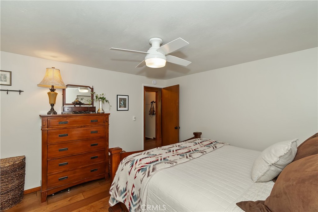 158 Golf Course Road Lake Arrowhead, CA 92391 - Photo 23 of 75 a bedroom with a bed and a chandelier