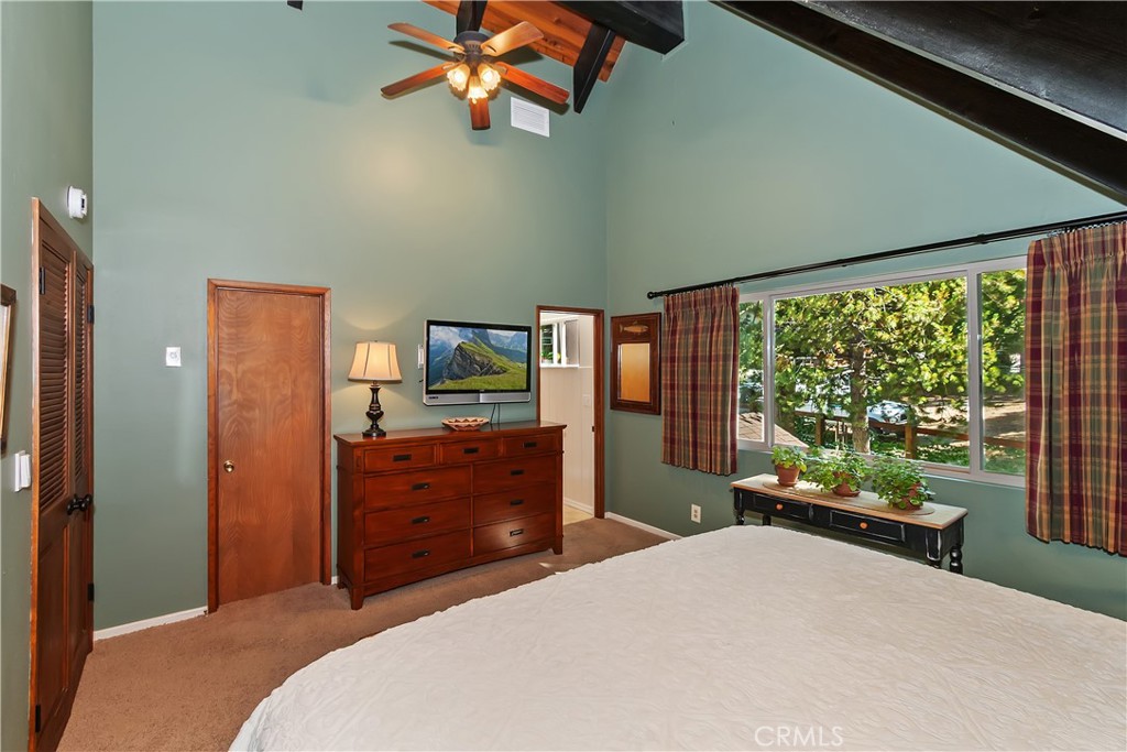 158 Golf Course Road Lake Arrowhead, CA 92391 - Photo 25 of 75 a bedroom with a bed and a large window