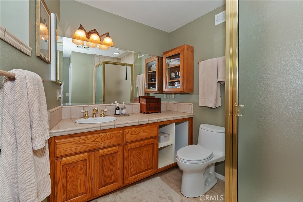 158 Golf Course Road Lake Arrowhead, CA 92391 - Photo 34 of 75 a bathroom with a toilet sink and mirror