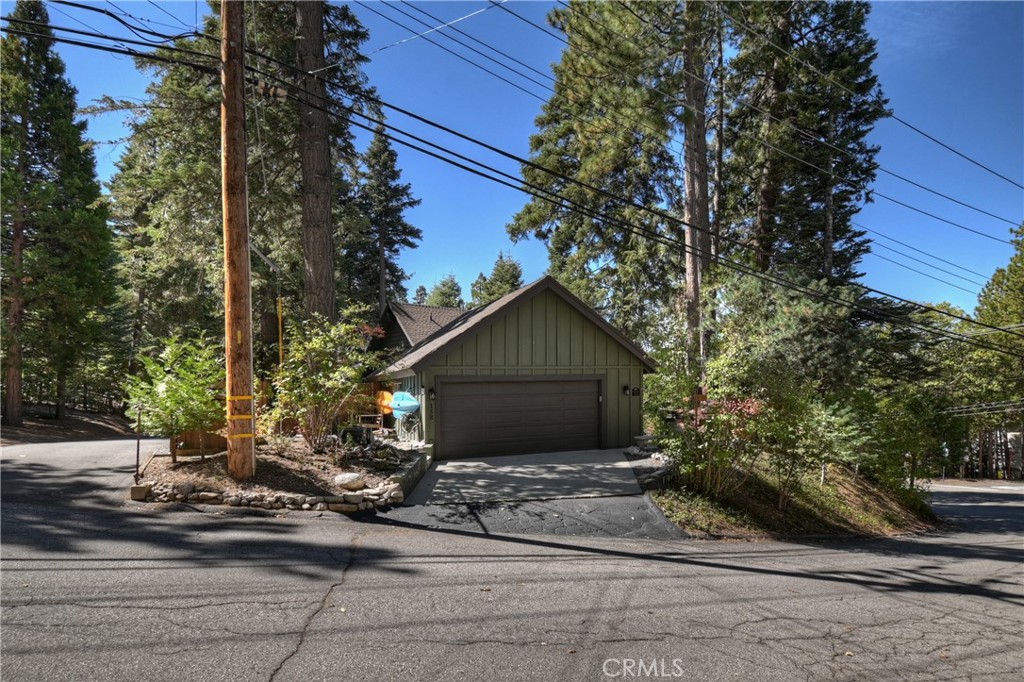 158 Golf Course Road Lake Arrowhead, CA 92391 - Photo 51 of 75 a front view of a house with a yard and garage