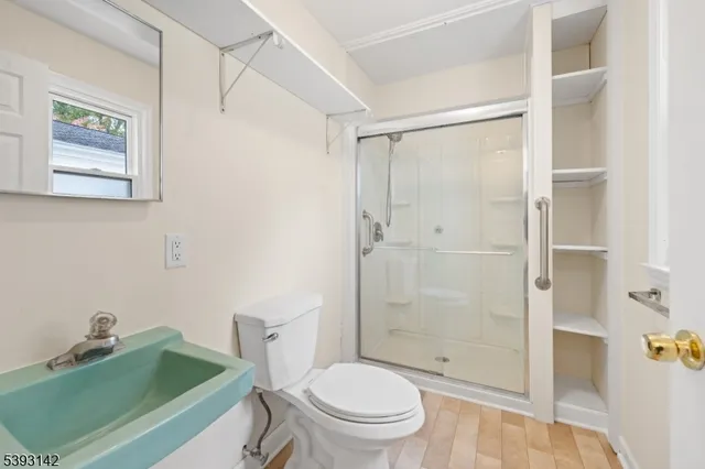 a bathroom with a toilet a sink and shower